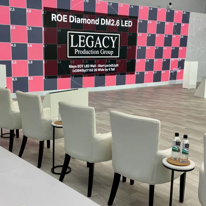 home-about-large Ice Rink LED video wall showing a pink-and-gray numbered calibration grid with ‘LEGACY Production Group’ branding;